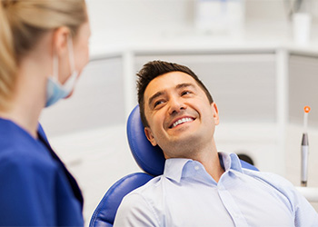 Male dental patient smiling at dentist