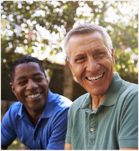 Group of men laughing together outdoors