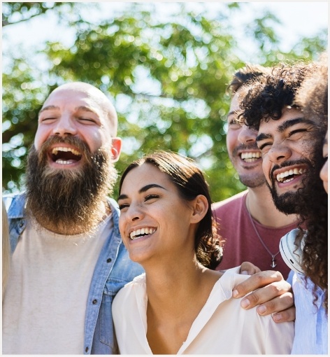 Several adults laughing together outdoors