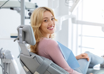Smiling patient sitting in treatment chair