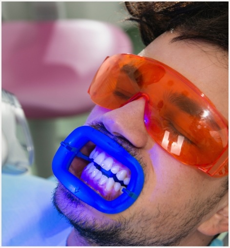 Man getting professional teeth whitening in dental office