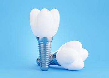 Two dental implants on a blue background