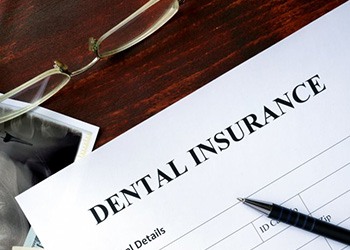 Paper that says Dental Insurance sitting on a desk