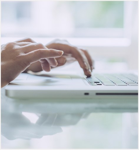 Person typing on laptop