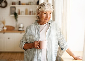 Senior woman drinking tea at home